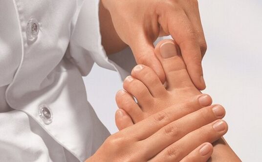 Specialist examines feet for fungal infections.